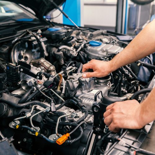 mechanic working on engine repairs, close up