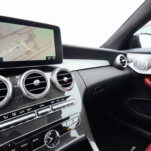 View from inside a car on a part of dashboard with a navigation unit